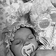 Gracelynn joined the competition — help win amazing prizes! baby, sleeping, pacifier, bonnet, dress, teddy_bear, soft_toy, blanket, floral_pattern, close_up, portrait, child, infant, cute, peaceful, black_and_white, hand, cozy, resting, indoors
