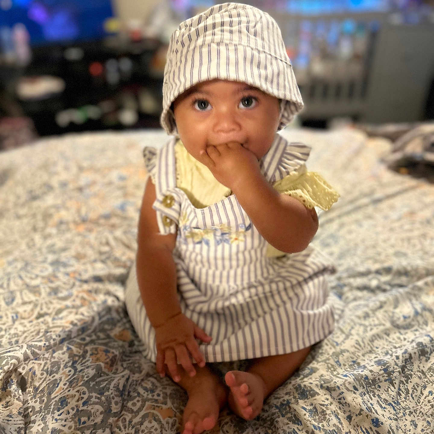 Patience joined the competition — help win amazing prizes! baby, bedspread, casual, child, cute, fabric, foot, furniture, hand_in_mouth, hat, indoor, infant, pattern, person, portrait, room, sitting, soft_light, striped_clothing, young_child
