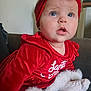 Charlotte a rejoint le concours — aidez-le/la à gagner de superbes lots ! baby, child, red_clothing, headband, blue_eyes, face, indoor, couch, sitting, cute, holiday_outfit, velvet, fur_trim, sock, expression, portrait, infant, closeup, person, soft_lighting