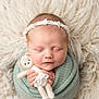 newborn, baby, sleeping, teddy_bear, soft_blanket, knit, headband, cute, infant, portrait, cozy, fluffy_rug, peaceful, wrapped, child, tiny_hands, face, closed_eyes, soft_lighting, indoors