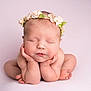 Bonnie is registered to the contest to win money with this photo: newborn, baby, flower_crown, sleeping, pose, hands, face, skin, head, peaceful, pink_background, infant, cute, portrait, child, soft_light, studio, peace, resting, adorable
