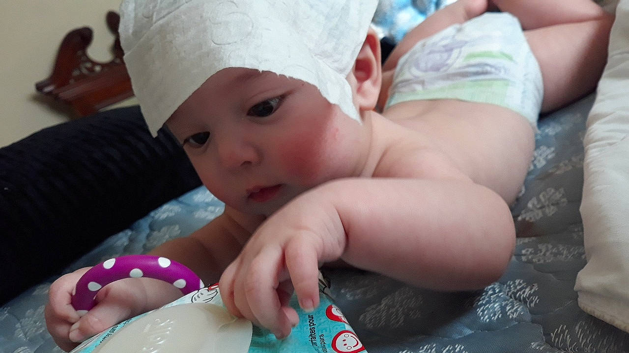 Augustine is registered to the contest to win money with this photo: baby_products, cheek, child, finger, fun, girl, hand, headwear, infant, leg, nail, person, product, skin, toddler