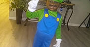 Khani joined the competition — help win amazing prizes! blue_overalls, casual_shoes, child, costume, decoration, face_paint, furniture, green_hat, home, indoor, living_room, luigi, peace_sign, plant, pose, smile, television, white_gloves, wooden_floor, young_boy
