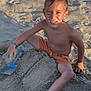 child, boy, sand, beach, shovel, sandcastle, sunlight, smiling, bare_chested, play, outdoor, vacation, summer, wet_hair, happy, fun, toy, recreation, nature, leisure