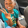 Khalani joined the competition — help win amazing prizes! child, girl, smiling, peace_sign, car_interior, hair_buns, butterfly_clips, teal_shirt, cartoon_characters, denim_shorts, sitting, seatbelt, water_bottle, casual, candid, happy, young, person, indoors, portrait