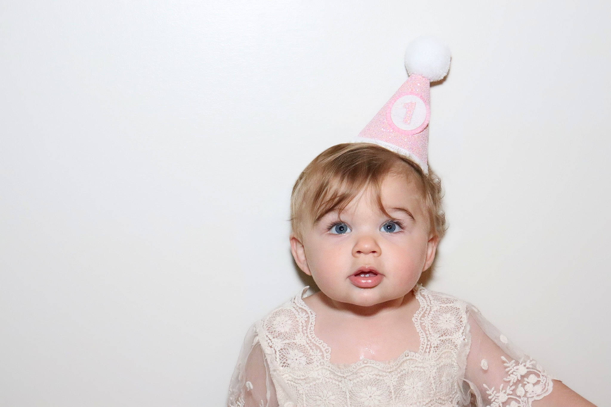 Emberly is registered to the contest to win money with this photo: baby, baby_toddler_clothing, bridal_accessory, cone, costume_hat, dress, embellishment, event, eye, eyelash, flash_photography, hair, happy, headgear, headpiece, jewellery, party_hat, party_supply, person, pink