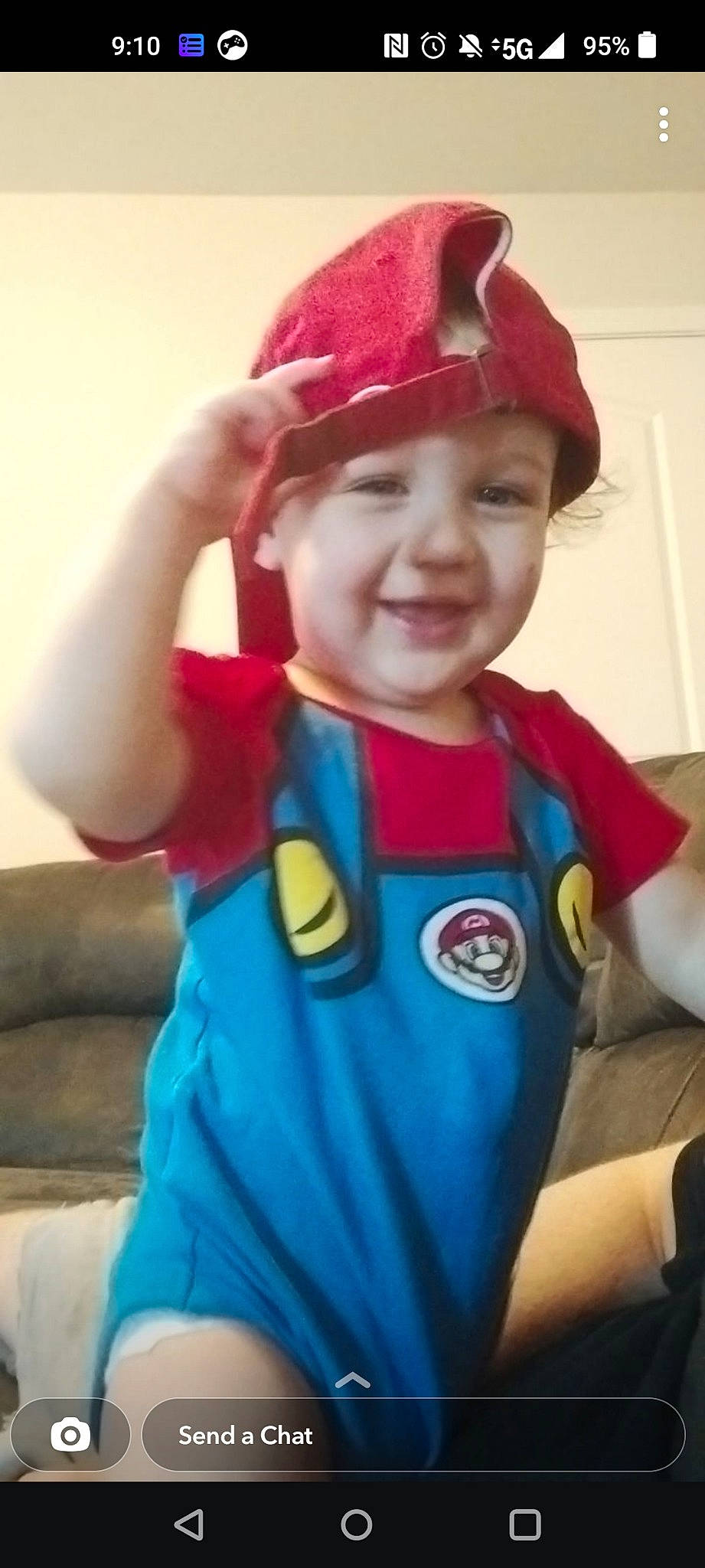 Braylen is registered to the contest to win money with this photo: arm, baseball_cap, cap, child, cool, costume_hat, electric_blue, fictional_character, fun, gesture, happy, headgear, headwear, joy, outerwear, party_supply, person, personal_protective_equipment, sleeve, smile