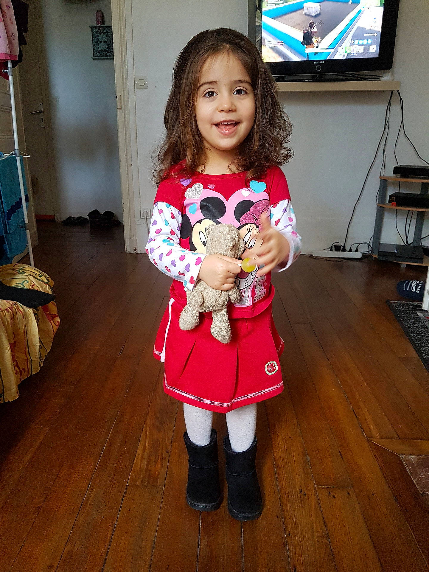 Aicha participe au concours pour gagner de l'argent avec cette photo : child, clothing, costume, day, dress, fashion, girl, joy, leg, outerwear, person, pink, product, red, shoulder, skin, smile, snapshot, socialite, standing