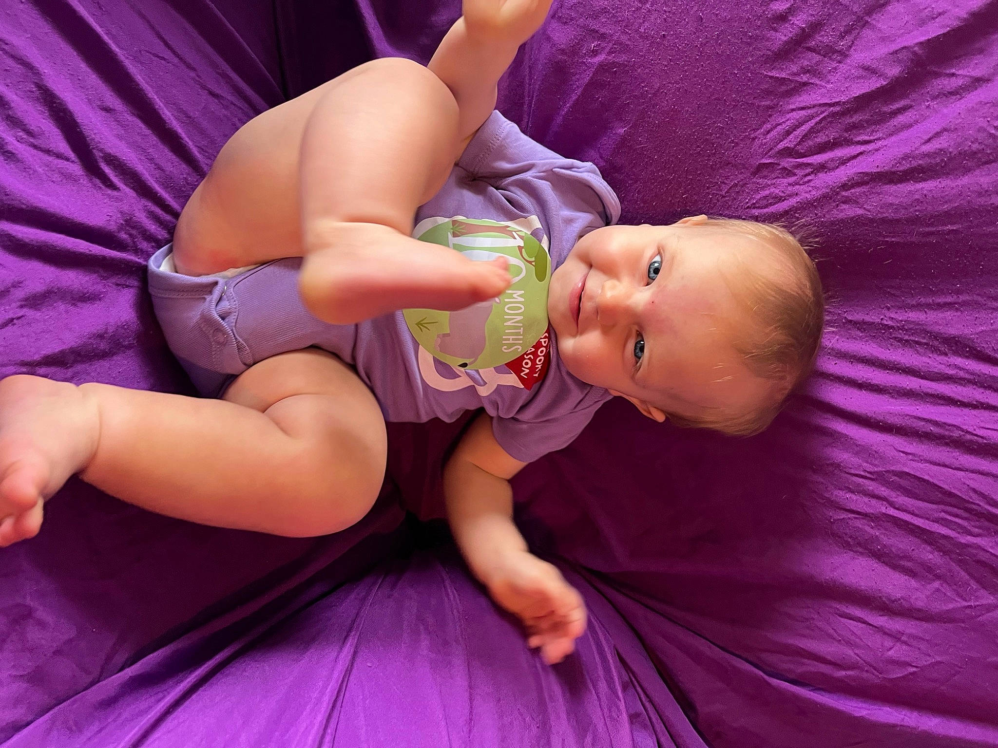 Macii is registered to the contest to win money with this photo: abdomen, baby, baby_toddler_clothing, child, comfort, finger, fun, happy, human_body, human_leg, joint, knee, leg, magenta, person, pink, purple, skin, thigh, toddler
