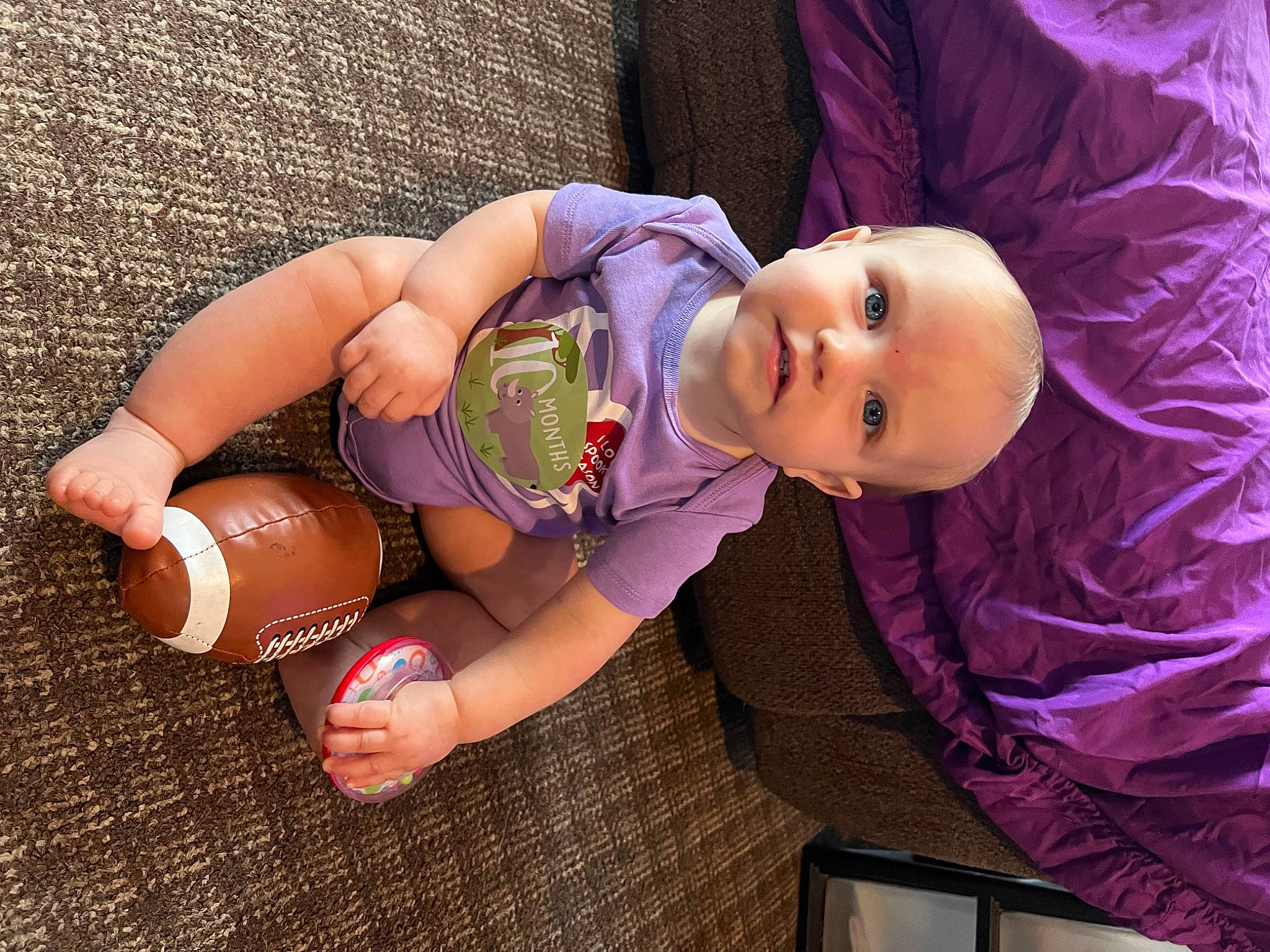 Macii is registered to the contest to win money with this photo: abdomen, baby, baby_products, baby_toddler_clothing, child, elbow, facial_expression, fun, hand, happy, headgear, human_body, human_leg, magenta, person, pink, purple, skin, smile, thigh