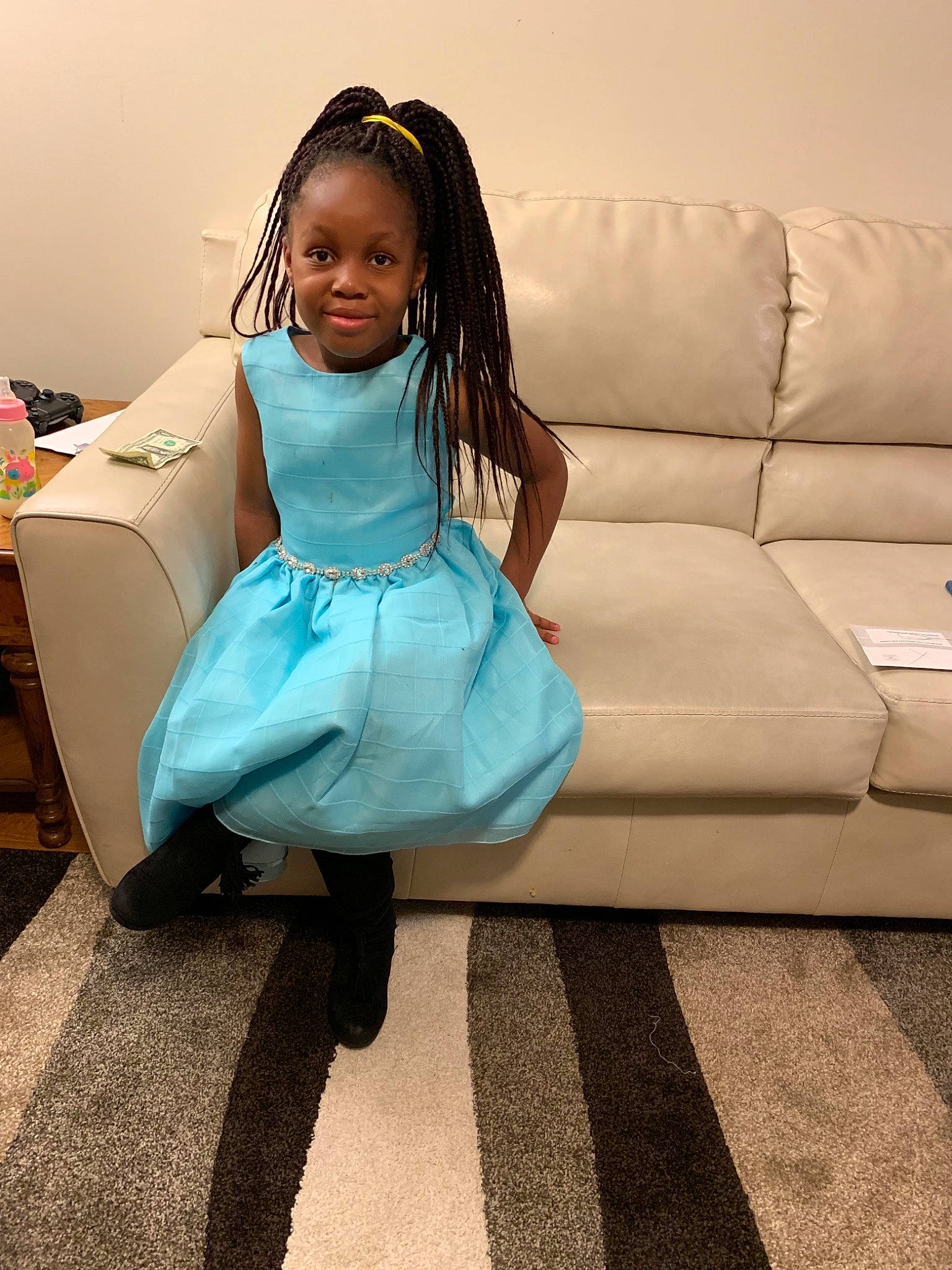 Karen is registered to the contest to win money with this photo: blue, child, couch, dress, floor, flooring, furniture, hairstyle, joy, leg, long_hair, person, pink, room, shoe, shoulder, sitting, skin, smile, toddler