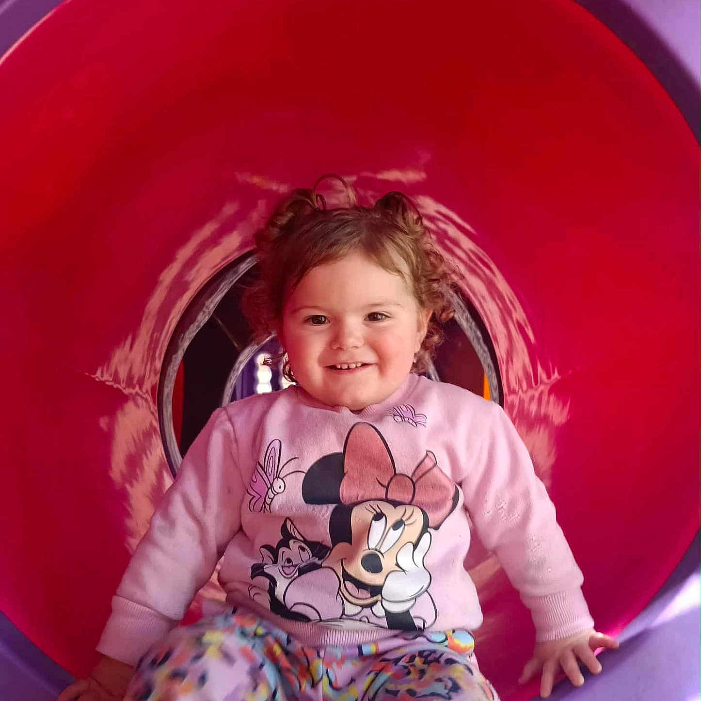Mackenzie-Lee joined the competition — help win amazing prizes! child, clothing, colorful, curly_hair, cute, fun, happy, indoors, leisure, minnie_mouse, pants, person, play, playground, sitting, smiling, sweater, toddler, tunnel, young