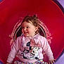 Mackenzie-Lee is registered to the contest to win money with this photo: toddler, child, curly_hair, smiling, playground, tunnel, pink_sweater, minnie_mouse, colorful, pants, happy, sitting, cute, fun, play, outdoor_toy, young_child, casual_clothing, joyful, portrait