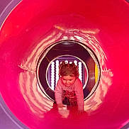 Mackenzie-Lee is registered to the contest to win money with this photo: child, toddler, curly_hair, pink_tunnel, purple_tunnel, playground, crawling, colorful, indoor_play_area, exploration, cute, young_child, play, fun, cute_expression, plastic_tunnel, active, small_child, casual_clothing, adventure