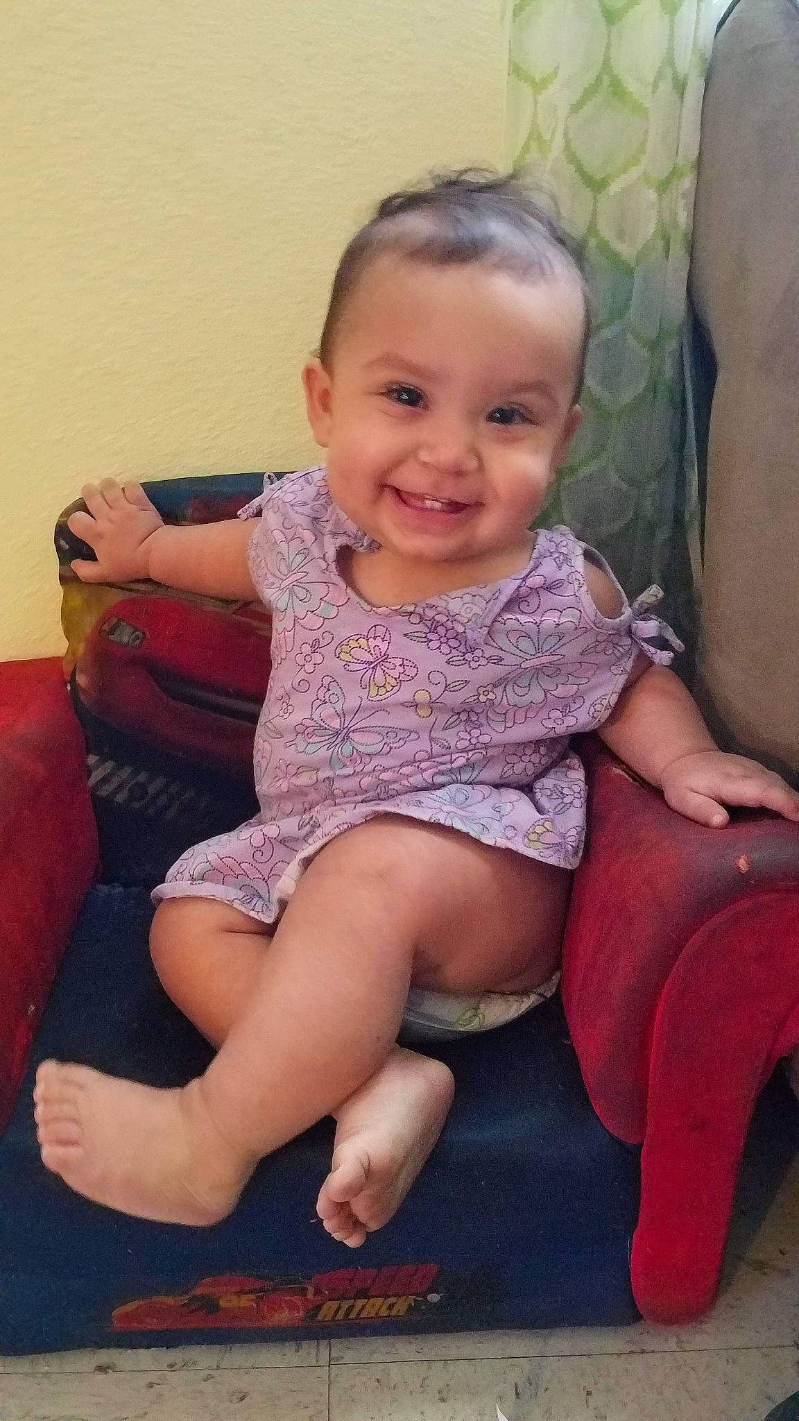 Lisa is registered to the contest to win money with this photo: arm, baby, barefoot, cheek, child, ear, facial_expression, finger, head, joy, leg, nose, person, sitting, skin, smile, sole, thigh, thumb, toddler