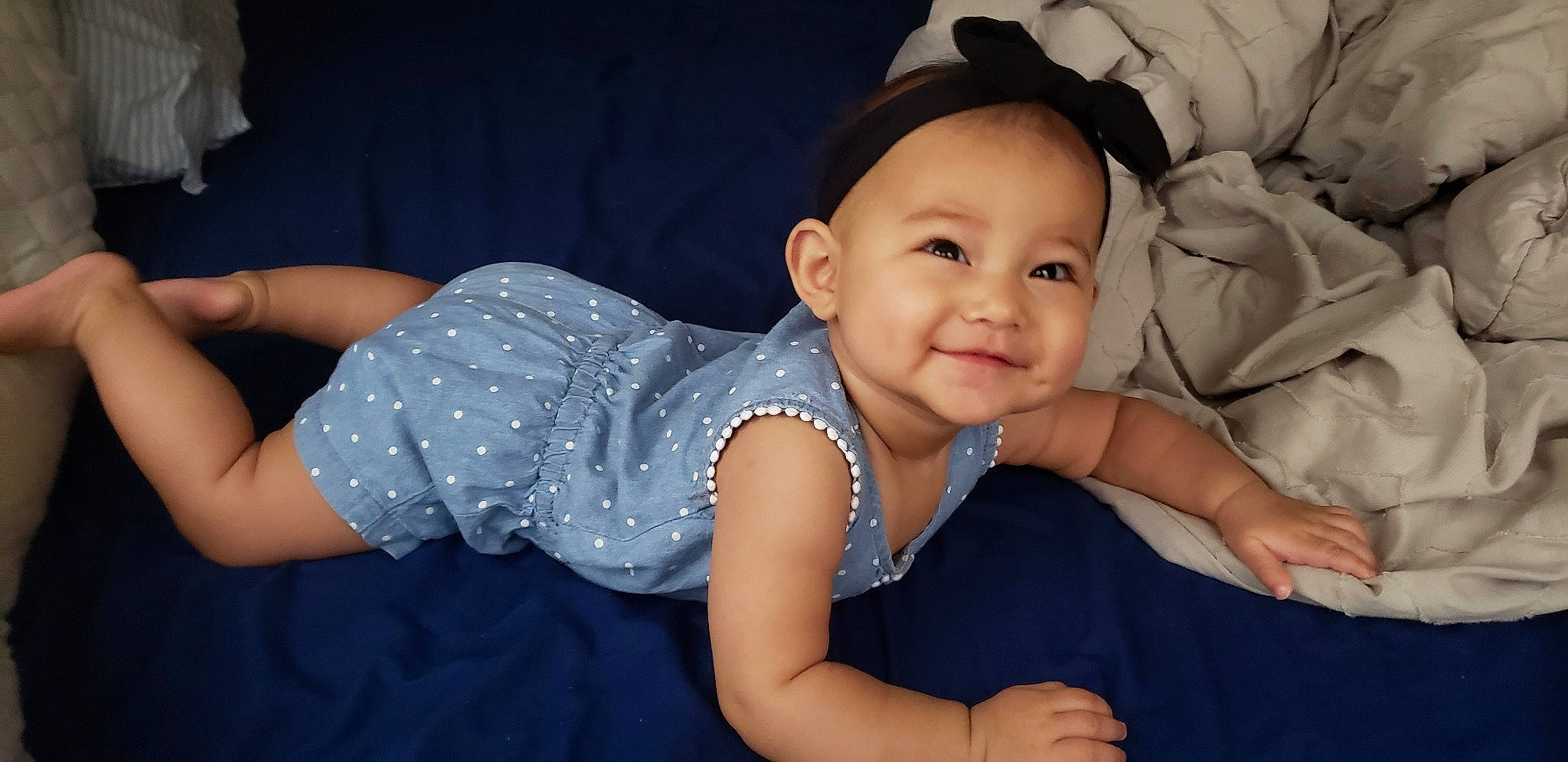 Marlie is registered to the contest to win money with this photo: arm, baby, cheek, child, ear, eye, fun, hat, head, headgear, person, sitting, skin, smile, toddler