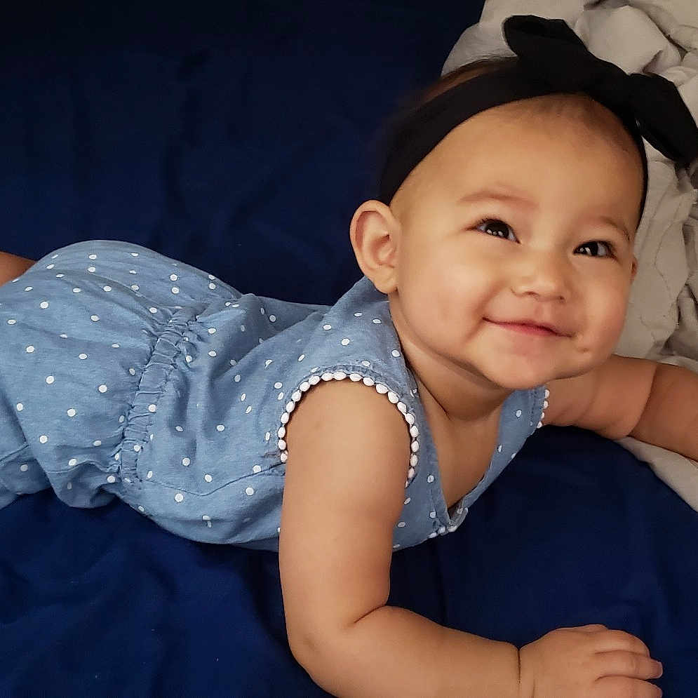 Marlie is registered to the contest to win money with this photo: arm, baby, cheek, child, ear, eye, fun, hat, head, headgear, person, sitting, skin, smile, toddler