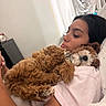 Mila joined the competition — help win amazing prizes! woman, person, dog, dogs, puppy, curly_hair, brown_dog, small_dog, white_dog, pet, cuddling, bed, bedroom, pillow, blanket, indoor, portrait, relaxed, sleeping, cute