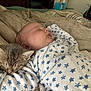 baby, kitten, sleeping, bed, blanket, onesie, stars_pattern, animal, pet, cozy, rest, child, furniture, indoor, cute, nap, face, peaceful, hand, soft