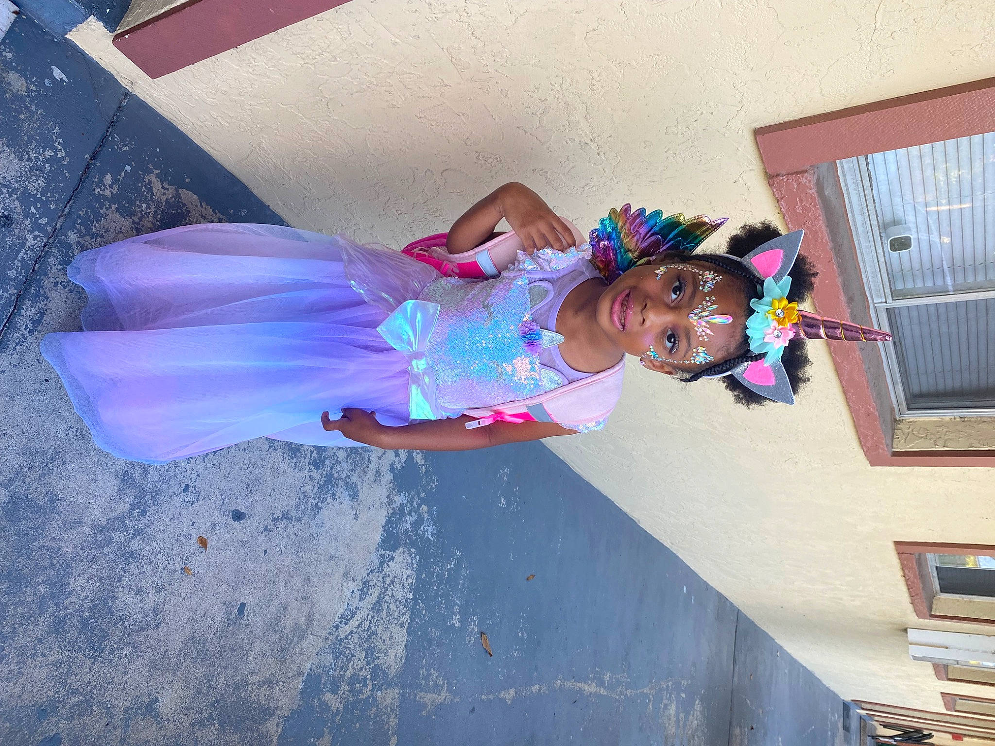 Calanie is registered to the contest to win money with this photo: azure, blue, child, costume, dress, electric_blue, event, facade, fun, happy, joy, leisure, magenta, person, pink, purple, smile, violet, window