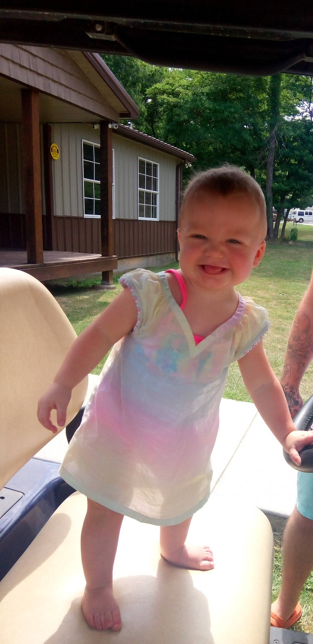 Izabella is registered to the contest to win money with this photo: child, cool, finger, fun, gesture, grass, happy, house, human_leg, joy, leisure, person, pink, recreation, shoulder, skin, smile, summer, thumb, toddler