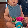 Wyatt is registered to the contest to win money with this photo: baby, bib, car_seat, casual, child, colorful, cute, diaper, expressionless, floor, holding, indoor, infant, playtime, plush_toy, sitting, teething_ring, toy, wooden_floor, young_child