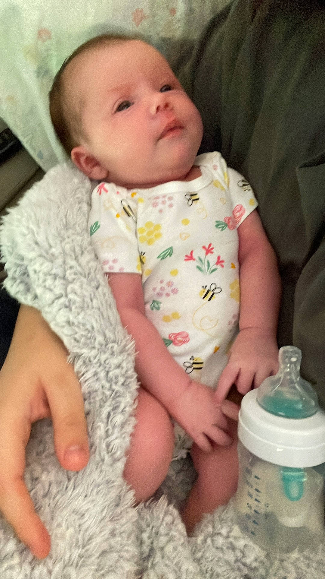 Riley is registered to the contest to win money with this photo: baby, baby_toddler_clothing, bottle, cheek, child, collar, comfort, drinking_water, drinkware, finger, green, hand, lip, nose, person, plastic_bottle, product, skin, sleeve, toddler