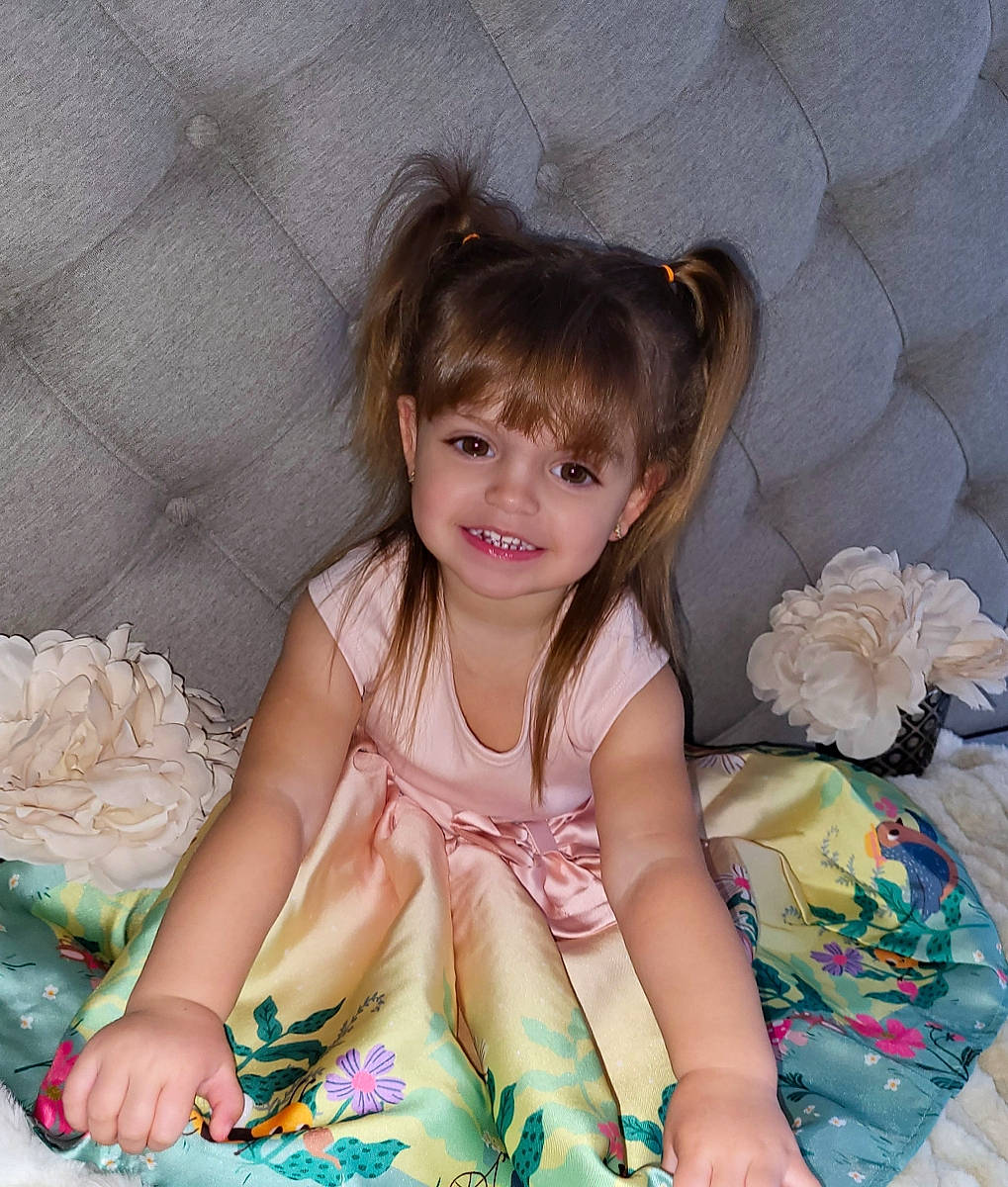 Leda is registered to the contest to win money with this photo: baby_toddler_clothing, beauty, blond, cheek, child, comfort, dress, eye, face, finger, fun, happy, head, joy, pattern, person, pink, product, sitting, smile