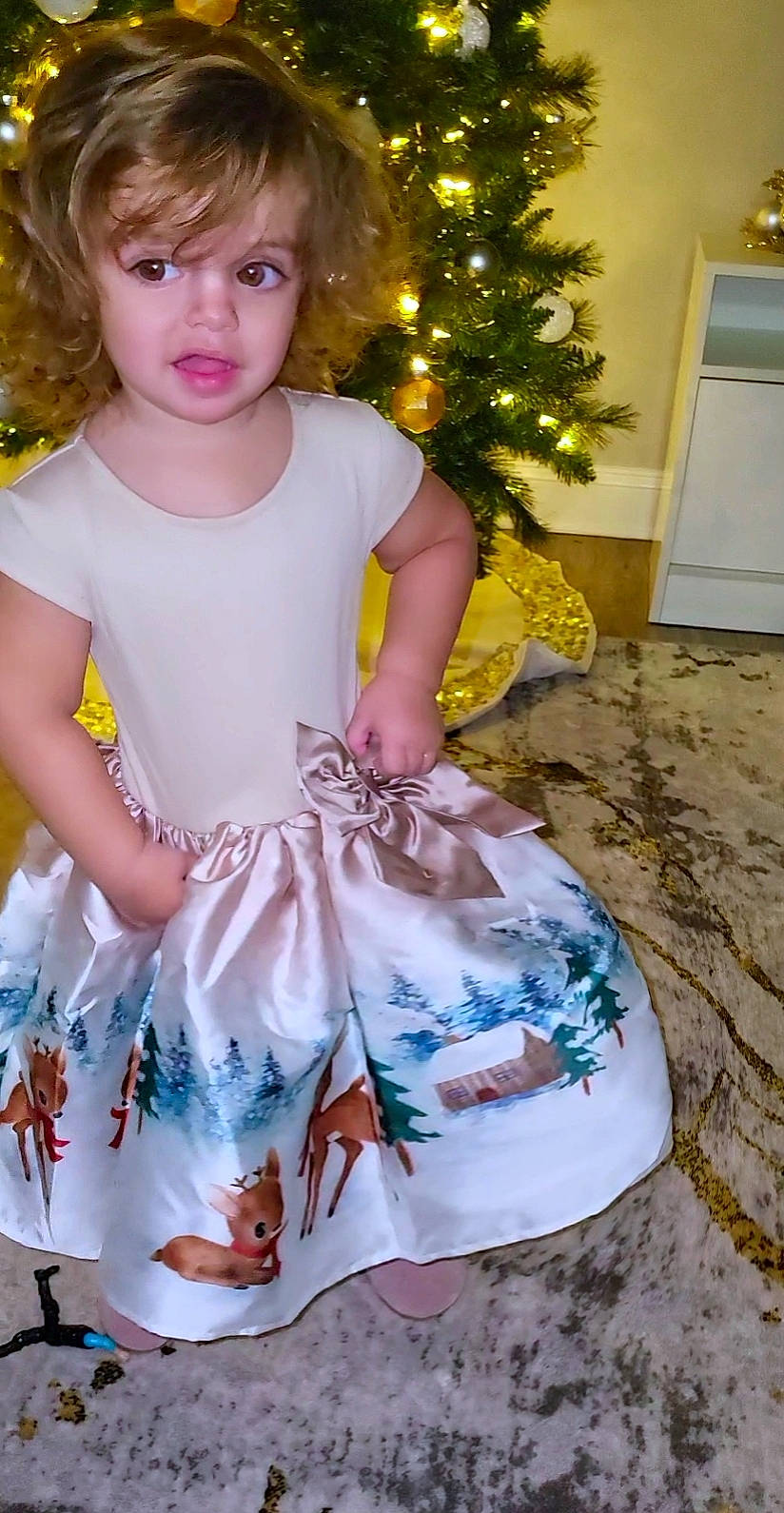 Leda is registered to the contest to win money with this photo: baby_toddler_clothing, child, christmas_decoration, christmas_ornament, christmas_tree, day_dress, dress, event, eye, happy, one_piece_garment, pattern, person, pink, plant, ruffle, sleeve, t_shirt, toddler, tree