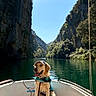 Peter participe au concours pour gagner de l'argent avec cette photo : adventure, boat, calm, canyon, cap, cliffs, dog, golden_retriever, greenery, leash, life_vest, nature, outdoor, pet, river, scenic, sky, sunlight, travel, water