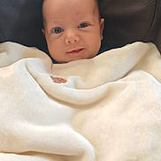 Lissandro participe au concours pour gagner de l'argent avec cette photo : baby, blanket, face, infant, child, smile, cushion, seat, cozy, soft, indoor, portrait, cute, wrapped, warm, young, head, eyes, person, comfort