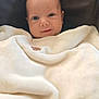 baby, blanket, face, infant, child, smile, cushion, seat, cozy, soft, indoor, portrait, cute, wrapped, warm, young, head, eyes, person, comfort