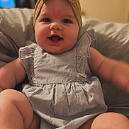 Oakleigh joined the competition — help win amazing prizes! baby, child, infant, headband, bow, smiling, happy, cute, chubby, dress, striped, sitting, indoors, soft_furniture, couch, face, portrait, closeup, skin, person