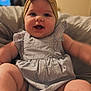 baby, child, infant, headband, bow, smiling, happy, cute, chubby, dress, striped, sitting, indoors, soft_furniture, couch, face, portrait, closeup, skin, person