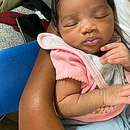 Niylah is registered to the contest to win money with this photo: baby, sleeping, infant, arm, pink_clothing, couch, blanket, person, closeup, indoor, skin, hand, comfort, peaceful, resting, toddler, holding, soft, cute, portrait