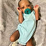 Roman joined the competition — help win amazing prizes! baby, infant, pacifier, blue_onesie, socks, blanket, lying_down, cute, child, newborn, sleepwear, soft_texture, human, skin, hands, face, head, resting, indoors, comfort