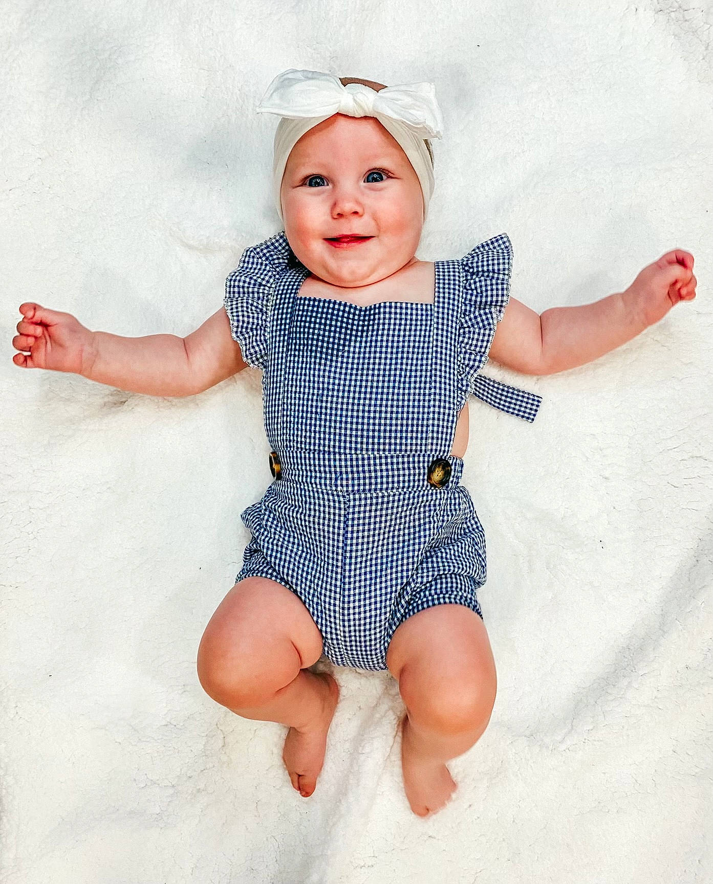 Adaline is registered to the contest to win money with this photo: arm, azure, baby_toddler_clothing, eye, face, finger, gesture, happy, head, headwear, human_body, iris, joy, neck, person, pink, product, skin, sleeve, smile
