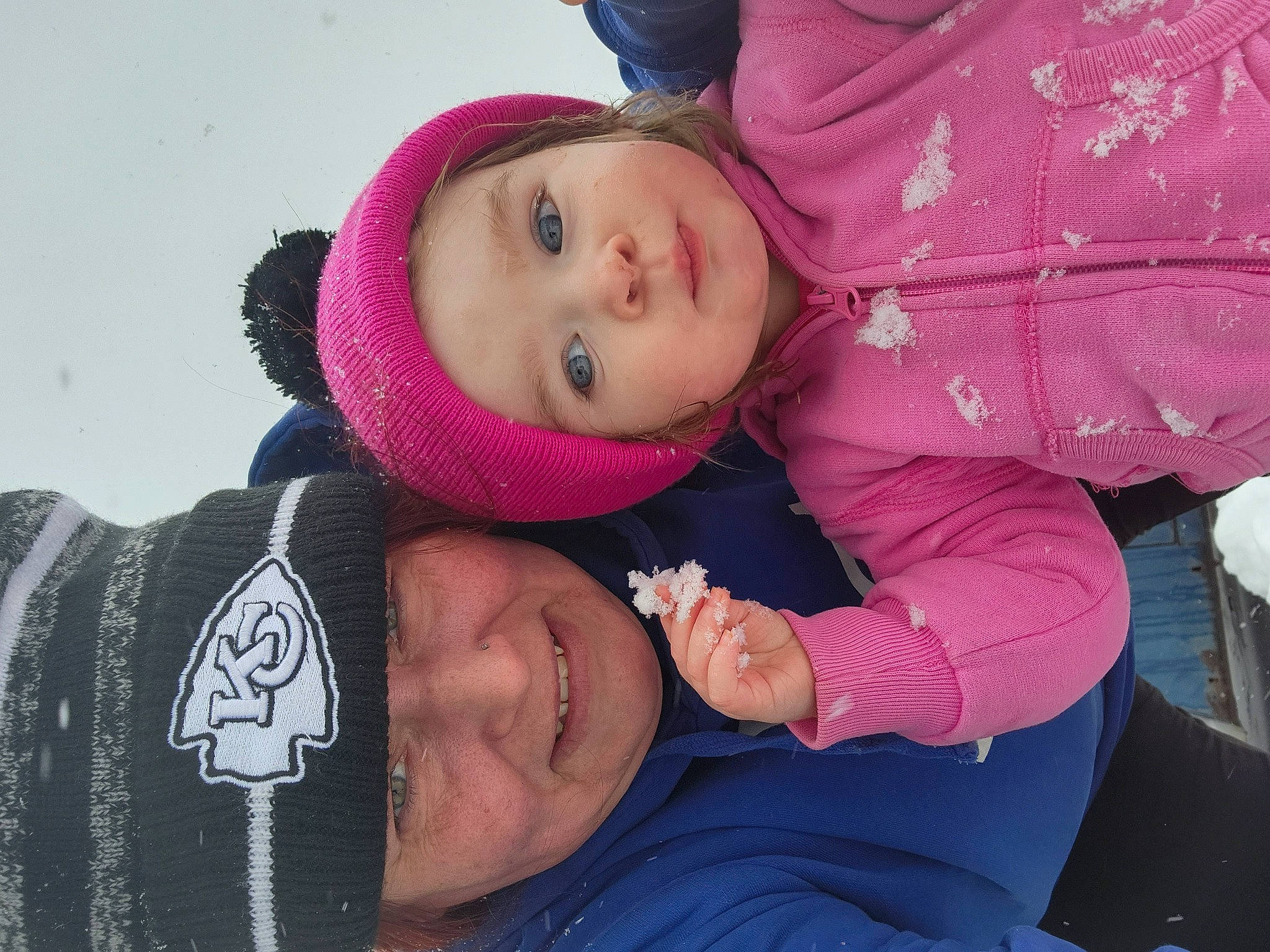 Layla R is registered to the contest to win money with this photo: baby, baby_toddler_clothing, cheek, child, clothing, comfort, event, fun, happy, headgear, headwear, magenta, mouth, person, pink, purple, skin, smile, snow, toddler