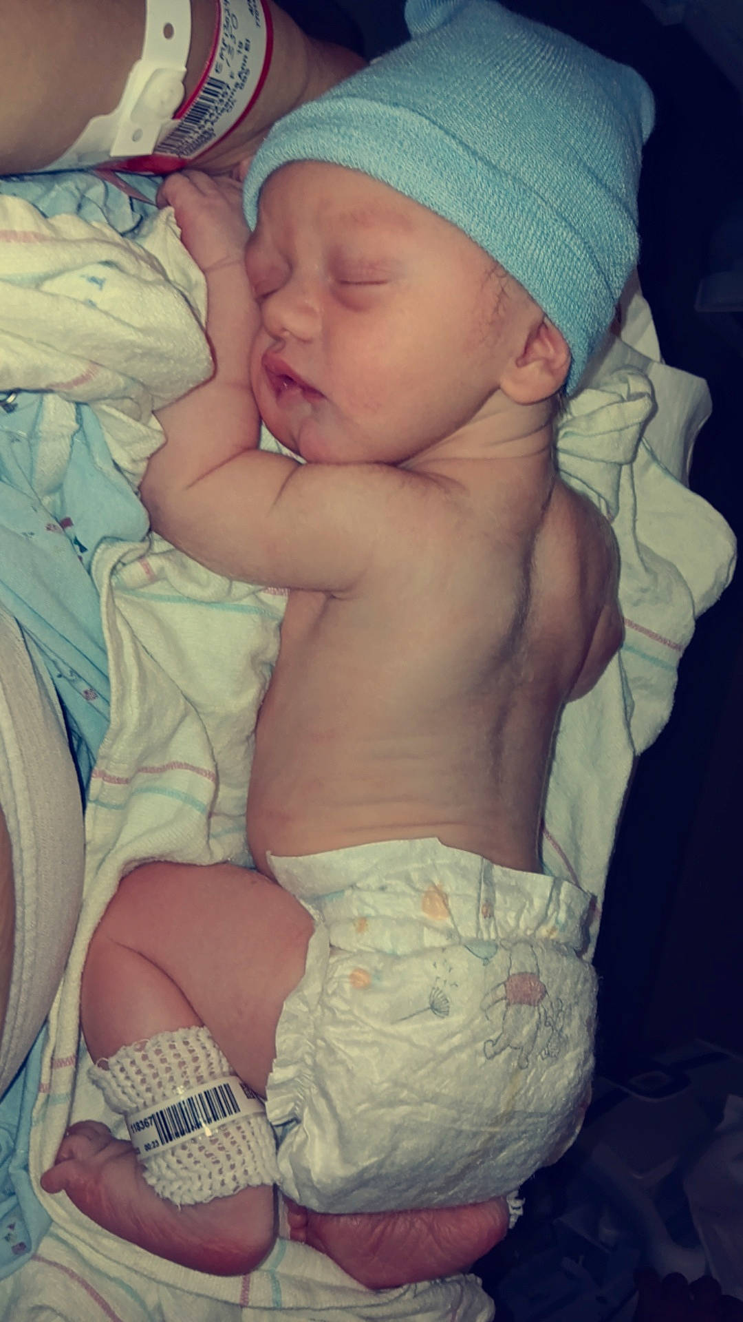 Kylen is registered to the contest to win money with this photo: arm, baby, baby_sleeping, baby_toddler_clothing, cap, cheek, chest, comfort, cool, finger, green, hand, headwear, mouth, organ, person, pink, skin, thigh, thumb