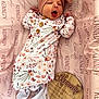 newborn, baby, infant, yawning, headband, bow, floral_onesie, pink_blanket, birth_announcement, wooden_plaque, name_kennedy, sleepwear, cute, lying_down, soft, cozy, portrait, indoors, baby_clothes, small_feet