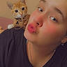 Oakland is registered to the contest to win money with this photo: black_shirt, cat, close_up, collar, duck_face, earrings, face, indoors, jewelry, kitten, necklace, orange_cat, orange_text, person, pet, playful, portrait, seated, selfie, shoulder