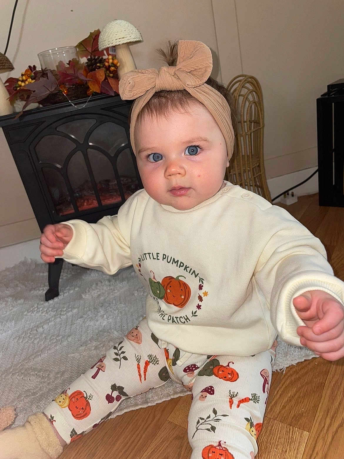 Pearl joined the competition — help win amazing prizes! baby, child, blue_eyes, headband, bow, sweater, pumpkin, leggings, autumn, decor, fireplace, rug, floor, indoor, person, cute, infant, seasonal, home, cozy