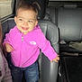 Wrenley is registered to the contest to win money with this photo: toddler, child, car_interior, smile, pink_jacket, jeans, standing, leather_seat, pigtails, happy, person, casual_clothing, seat, window, daylight, cute, small_child, hooded_jacket, footwear, car_trip
