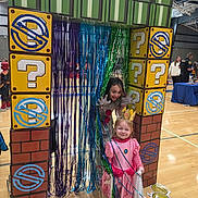 Oktober is registered to the contest to win money with this photo: children, costumes, princess, playful, streamers, question_mark_blocks, indoor, gym, floor, curtain, fun, party, decorations, happy, smiling, people, police_officer, event, celebration, colorful