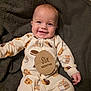 Killian joined the competition — help win amazing prizes! baby, infant, smiling, pajamas, milestone, wooden_sign, milk_carton_pattern, cookie_pattern, blanket, cute, child, lying_down, happy, indoors, portrait, six_months, cozy, comfortable, hand, face