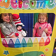 Killian joined the competition — help win amazing prizes! child, costume, dress, banner, crayons, string_lights, smile, happy, party, celebration, colorful, indoor, group, portrait, face, hat, pink_dress, playful, event, kids