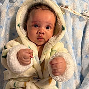 Azael is registered to the contest to win money with this photo: baby, infant, child, portrait, close_up, hooded_robe, blanket, blue_blanket, fluffy, wide_eyed, looking_at_camera, fists, hands, indoor, cozy, lying_down, baby_clothing, soft_texture, warm_lighting, cute