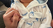 Lux joined the competition — help win amazing prizes! baby, infant, pacifier, bathrobe, shark_pattern, hand, holding, sleeping, cozy, indoor, person, cute, comfort, love, family, relaxation, skin, clothing, portrait, casual
