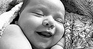Lux joined the competition — help win amazing prizes! baby, smiling, sleeping, blanket, cozy, black_and_white, infant, cute, face, arm, soft_texture, portrait, resting, closeup, newborn, child, happy, peaceful, skin, nap