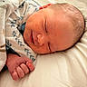 Lux is registered to the contest to win money with this photo: newborn, baby, sleeping, blanket, hand, fist, face, infant, cozy, soft_lighting, bed, cute, peaceful, child, young, portrait, skin, hair, comfort, closeup